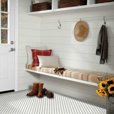 black and white penny tile in entryway with white shiplap walls and earth toned colours